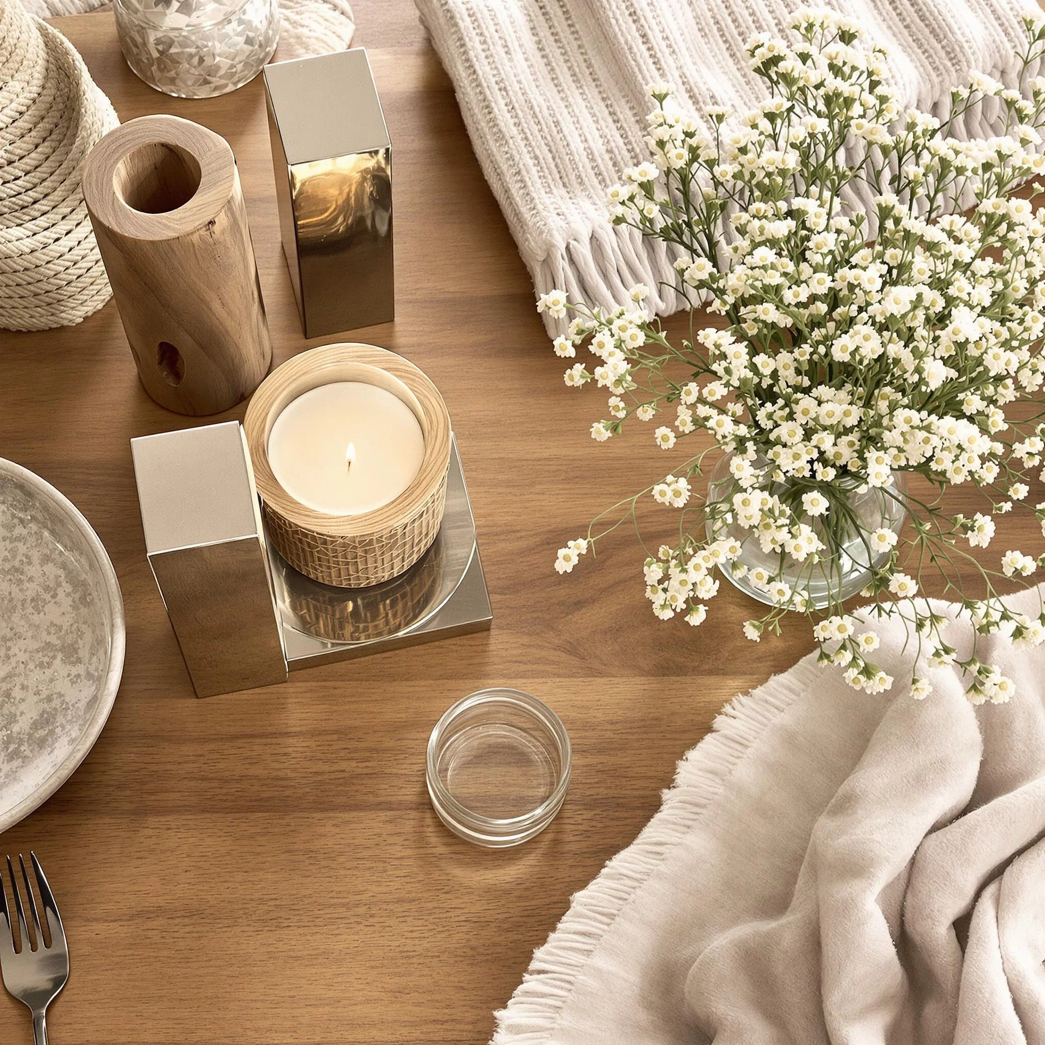 variety of cozy home decor items displayed on a table,